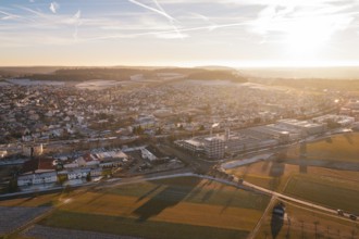 Expansive aerial view of a town in winter at sunset with fields in the foreground, Althengstett,