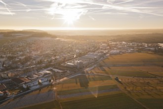 Sunset scene with a town and vast fields in the foreground, Althengstett, Calw district, Germany