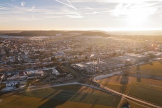 View of a city in the evening with a winter landscape and long shadows in the fields, Althengstett,