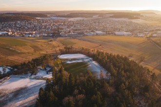 Extensive view of a snowy landscape with a sports field and surrounding trees, Althengstett, Calw