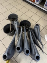 Winter, water cans and buckets with washing water for car windows, are provided in a gas station,