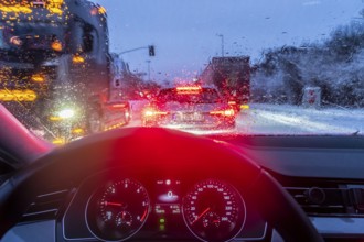 Driving in winter, in snow, rain, rear lights, brake lights, speedometer, cockpit