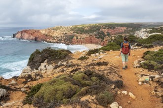 Hiking woman, view over cliff, Fishermens Trail, Rosa Vicentina, western Algarve just north of cape