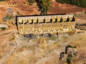 Ruins of former ore dock, Mina de Sao Domingos, historic copper open-pit mine, aerial view,