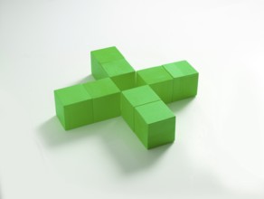 8 green wooden cubes against a white background
