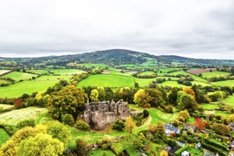 Autumn Colours over ruins of Grosmont Castle from a drone, Grosmont, Monmouthshire, Wales, UK