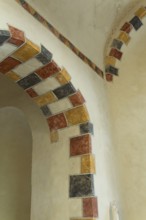 Painted arch in red, yellow and black. St Aignan's Church of Begues. Allier department. Auvergne