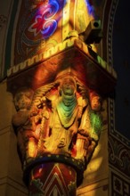 Issoire. Pillar (The Annunciation made to Mary) . The figures are illuminated by colorful light