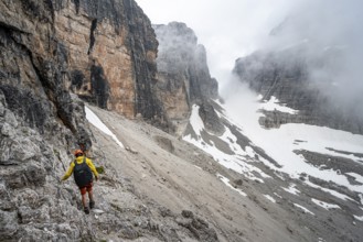 Two mountaineers descending to Rifugio Alimonta, Brenta Mountains, Trentino, Italy