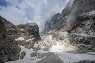 View of mountain basin with steep cliffs covered in clouds, Via Ferrata Oliva Detassis via ferrata,