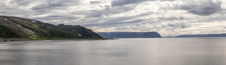 Coastal panorama with Tanafjord, mountains and dramatic sky with clouds, Store Molvik, Berlevåg,