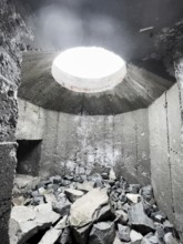 Old Wehrmacht anti-aircraft bunker from the Second World War with worn stairs in a dilapidated,