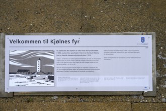 Iformative panel about Kjølnes Fyr lighthouse on a concrete floor with coastal illustration,