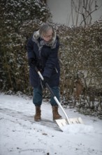 Elderly woman sweeping week with snow shovel, snow shovel, snow remover, shovel, clear, shovel