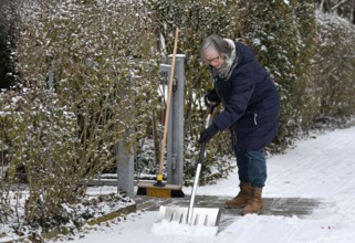 Elderly woman sweeping week with snow shovel, snow shovel, snow remover, shovel, clear, shovel