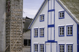 A traditional building with blue and white accents and a striking façade is seen next to an