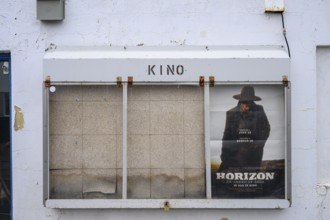 Cinema poster on a white painted wall with some peeling paint, Berlevåg, Finnmark, Norway