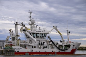 Large fishing vessel in harbor, with cloudy sky, Berlevåg, Finnmark, Norway