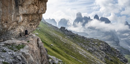 Mountaineers on a trail in front of picturesque mountain landscape with rocky peaks, Via Ferrata
