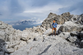 Mountaineers between large boulders, rocky mountain landscape, Via Ferrata SOSAT via Ferrata, in