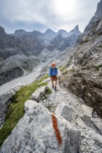 Mountaineers on a hiking trail with red trail markings, rocky mountain landscape, Via Ferrata SOSAT