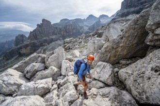 Mountaineers among large boulders, rocky mountain landscape, Via Ferrata SOSAT via ferrata, Brenta