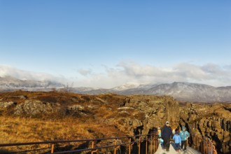 Walkers, tourists on hiking trail, Þingvellir National Park, impressive Almannagja Gorge,