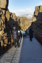 Walkers, tourists on hiking trail, Þingvellir National Park, impressive Almannagja Gorge,