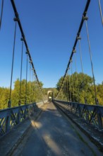 Suspension bridge of Coudes village on river Allier. Puy de Dome. Auvergne Rhone Alpes. France