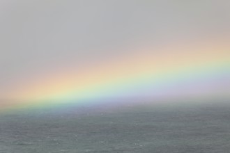 Tallow Beach bay with rainbow, lookout Byron Bay lighthouse, New South Wales, Australia