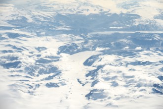 Icy, snowy arctic mountain landscape with glaciers, aerial view, Greenland, Arctic