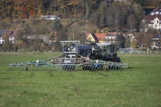 Farmer fertilizing his meadows by tow hose, Eschenbach, Middle Franconia, Bavaria, Germany