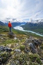Climber enjoying the view, Slaughter Ridge Trail, view of snowy mountains and turquoise blue Kenai