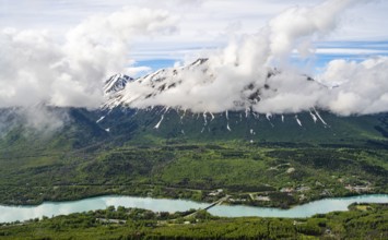 View of snowy mountains in spring and turquoise blue Kenai River, Slaughter Ridge Trail, Cooper