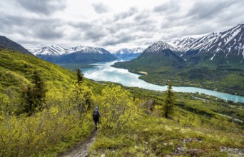 Climbers on a hiking trail, Slaughter Ridge Trail, view of snowy mountains in spring and turquoise