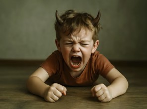In little boy with devil horns screams and cries angry and angry, symbol anger, angry, upbringing,