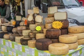 Various cheeses for sale on a table at market in Alghero, Sardinia, Italy