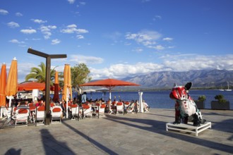 Restaurant at the marina in Calvi, with the mountains of the Balagne region in the Haute-Corse