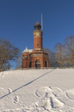 Holtenau lighthouse at the entrance of the Kiel Canal in winter, west bank of the Kiel Fjord,