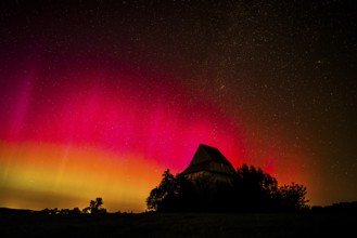Colourful polar lights over the EXPO observatory in front of a starry night, EXPO Observatory,