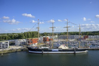 Harbour view with the legendary four-masted PASSAT barque and many boats in front of modern