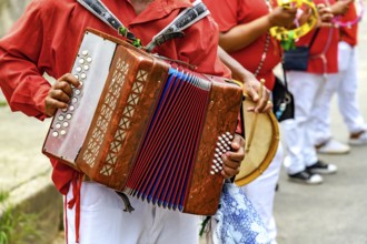 Accordion player with his instrument during a Congado religious festival in the state of Minas