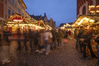 December 22, 2025, Frankfurt Christmas Market on Roemerberg at twilight. Traditional wooden stalls