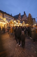 December 22, 2025, Frankfurt Christmas Market on Roemerberg at twilight. Traditional wooden stalls