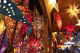 December 22, 2025, many glowing Christmas stars hanging at a marke t stall near St. Paul's Church,