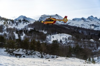 Rescue helicopter performing a search and rescue operation, transporting personnel and equipment