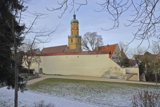 St. Blasius town church built in 14th century with historic city wall in winter with snow,