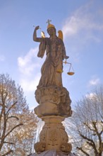 Justice as an angel and golden crown with cross, and beam scale, golden wings, symbol of justice