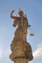 Justice as an angel and golden crown with cross and beam scale, golden wings, symbol of justice and