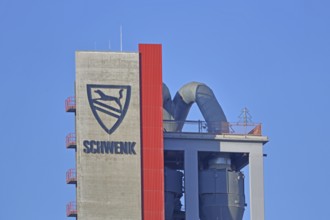 Silo with inscription and emblem of Zementfabrik Schwenk Manufacture of cement, tower with pipes,